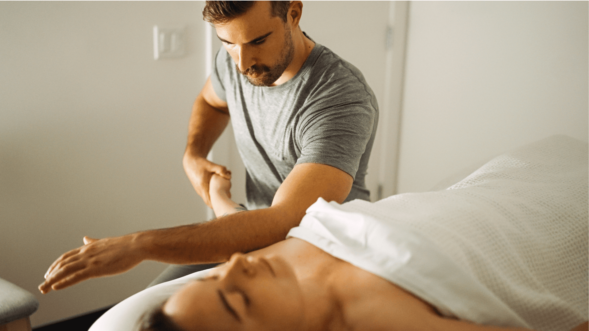 RMT Jacob Ball performing therapeutic massage treatment in clinic