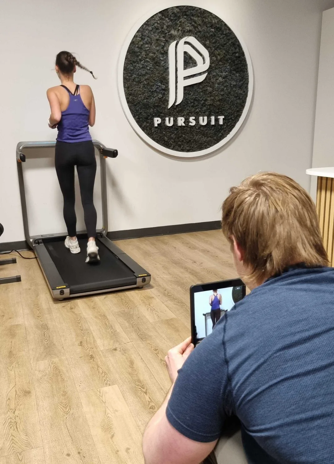 Clinician assessing running form and movement patterns